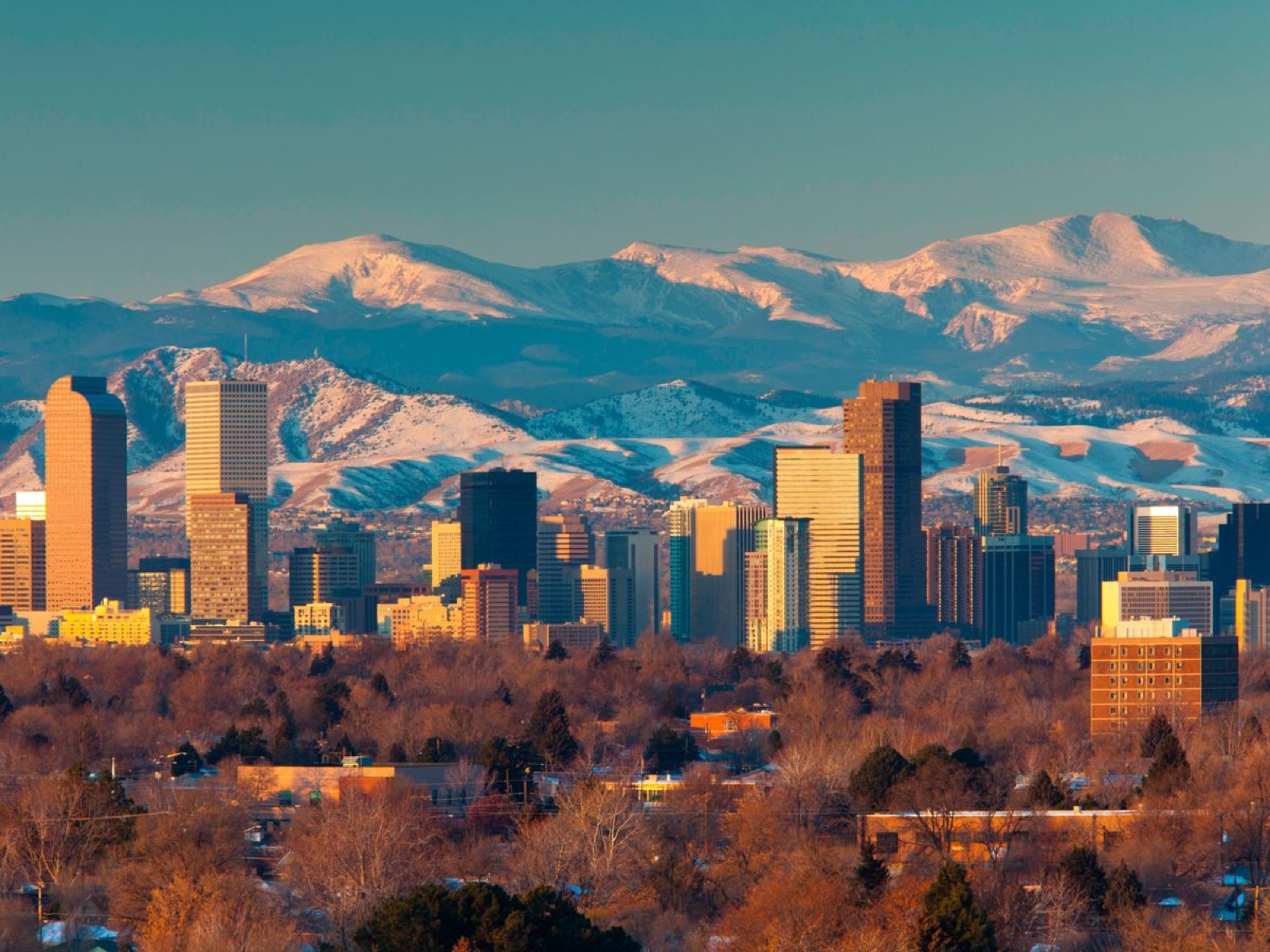 The Denver skyline with the snow-covered Front Range behind it