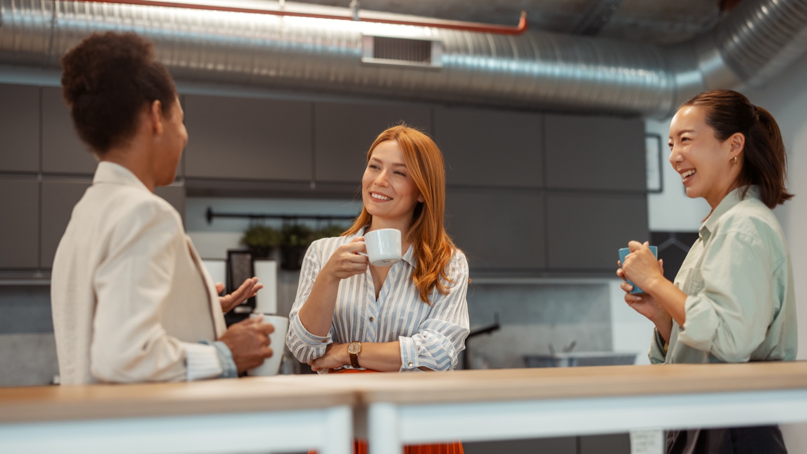 Colleagues enjoying coffee in a modern office